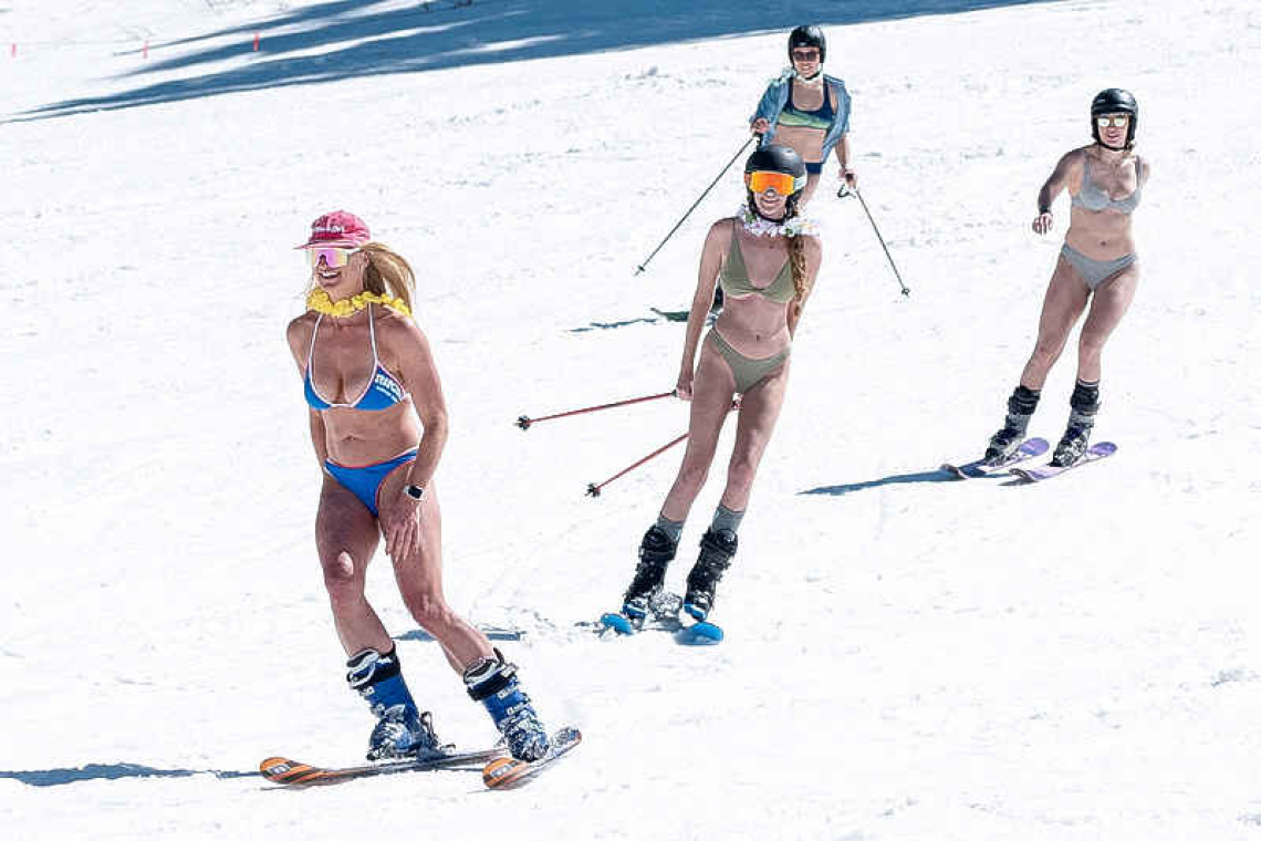 In record heat, American ski resorts  bulldoze snow, skiers wear bikinis